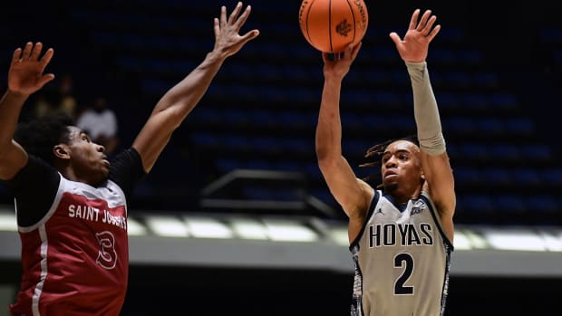 Nov 26, 2021; Anaheim, CA, USA; Georgetown Hoyas guard Dante Harris (2) shoots against Saint Josephs Hawks guard Cameron Brown (3) during the second half of the Wooden Legacy at Anaheim Arena. Mandatory Credit: Gary A. Vasquez-USA TODAY Sports